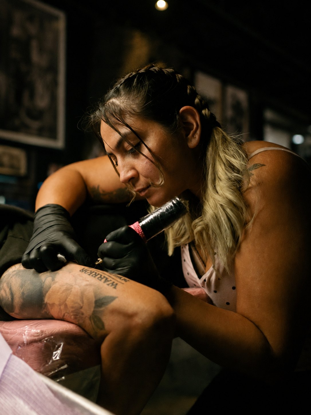 Aby tattooing a client at Thorn & Oath Tattoo Company